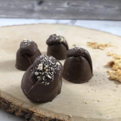 milk chocolate truffles on wood with hazelnuts