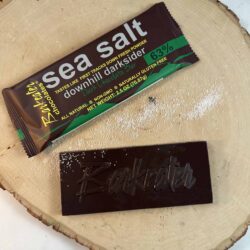 unwrapped and wrapped dark chocolate bar with sea salt