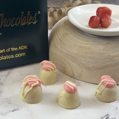 white chocolate truffles with a plate of strawberries