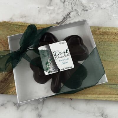 Dark chocolate four leaf clover in box with clear lid