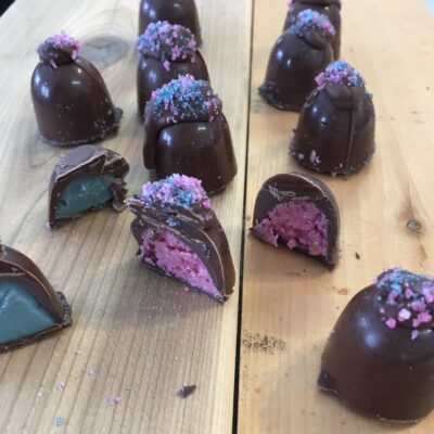 pink and blue truffles loose on a table