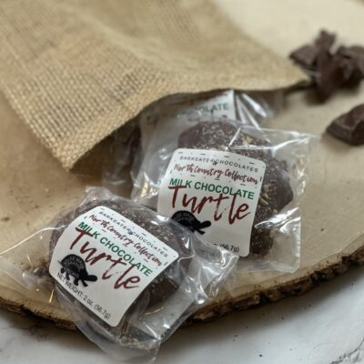 packaged caramel turtles coming out of a burlap sack