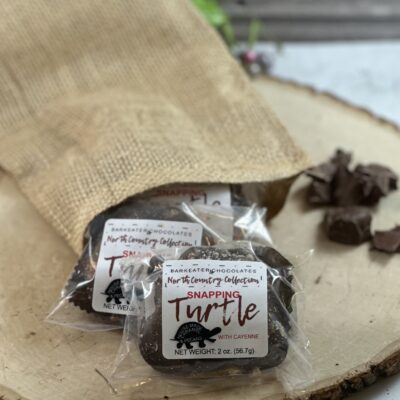 Packaged Chocolate Caramel Turtles coming out of burlap sack