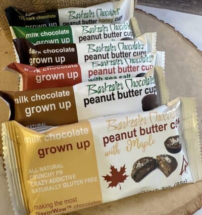 6 sleeves of assorted peanut butter cups lined up on wood