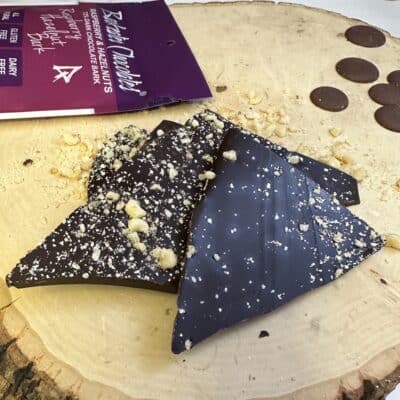 Dark Chocolate pieces with hazelnuts loose on wood