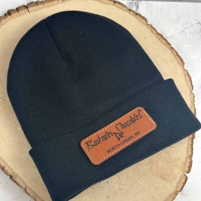 Black knit cap with leather patch that says Barkeater Chocolates North Creek NY