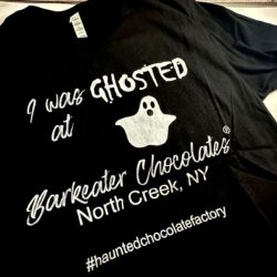 black shirt with white writing that says I was Ghosted at Barkeater Chocolates North Creek NY #hauntedchocolatefactory and ghost drawing