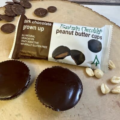 Dark Peanut Butter Cups loose and packaged on wood slab