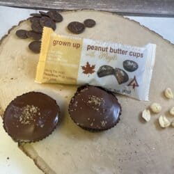 Maple Peanut Butter Cups Loose and in a package with peanuts and chocolate on wood