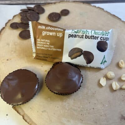 Millk Chocolate PB Cups loose and packaged on wood slab