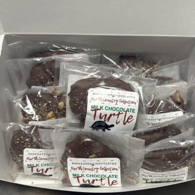 a box of packaged chocolate caramel turtles